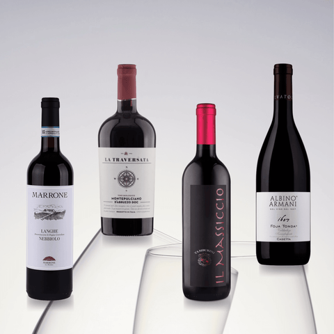 Four bottles of Italian red wine from regions including Langhe Nebbiolo, Montepulciano d’Abruzzo, and Foja Tonda Cassetta.