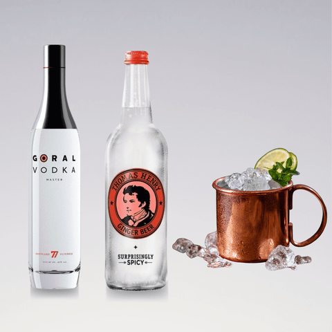 Moscow Mule ingredients: vodka, ginger beer, and a copper mug with ice, lime wedge, and mint sprig. Refreshing cocktail setup.