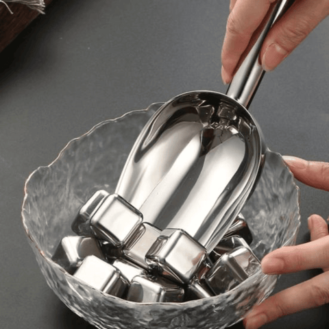 Stainless Steel Ice Scoop 9 cm with ice cubes in a glass bowl, perfect for elegant bar settings.