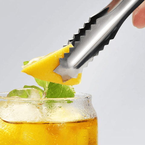 Stainless Steel Ice Tong holding a lemon slice over a refreshing drink, showcasing style and precision for home and bar use.