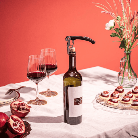 Vacu Vin Wine Set Classic with wine bottle opener, glasses, and appetizers set on elegant table.