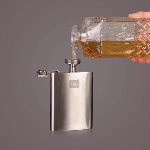 Vacu Vin Hip Flask Stainless Steel 200 ml with whiskey being poured from a glass decanter