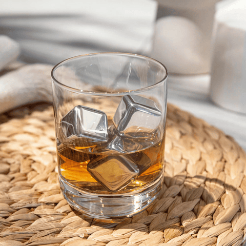 Glass with Vacu Vin Whiskey Stones Stainless Steel Set on woven mat