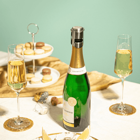 Vacu Vin Champagne Stopper Stainless Steel on champagne bottle, preserving fizz with glasses and snacks in elegant setting.