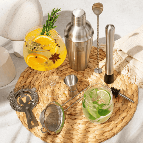 Vacu Vin Bar in a Box Cocktail Set featuring 7 essential bartending tools on a woven mat with vibrant cocktails.