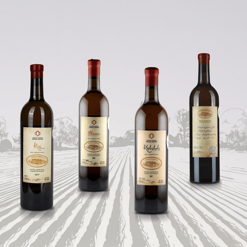 Georgian Amber Qvevri Wine Set showcasing four wine bottles crafted using the ancient clay qvevri method, featuring Kisi variety.