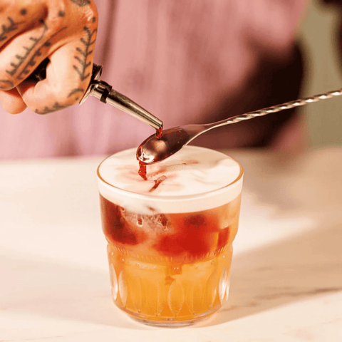 Bartender using Vacu Vin Bar Spoon Stainless Steel to create a cocktail